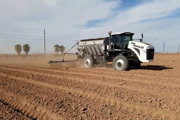 A spreader fertilizing a field